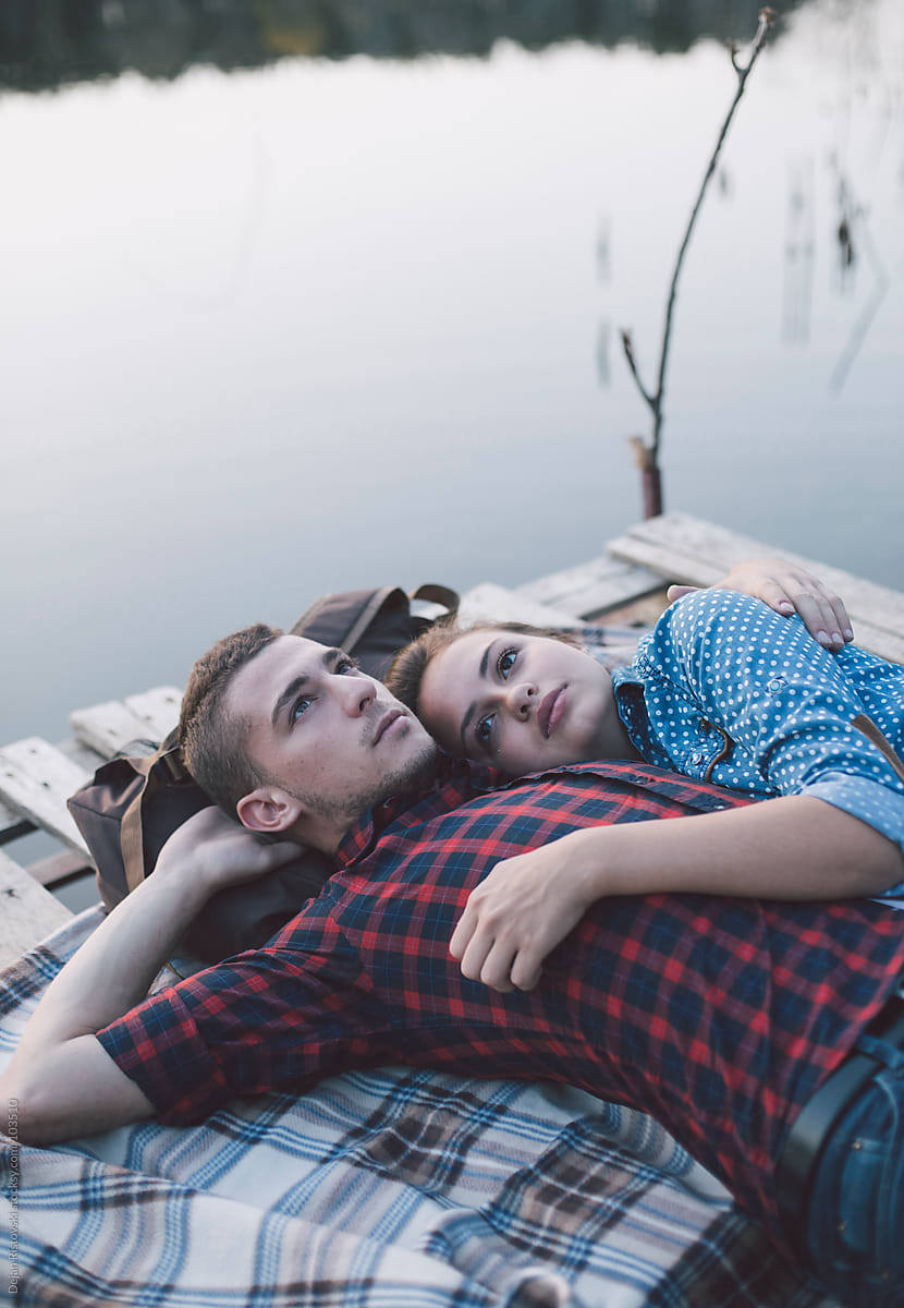 Couple Lying By The Lake By Dejan Ristovski Stocksy United