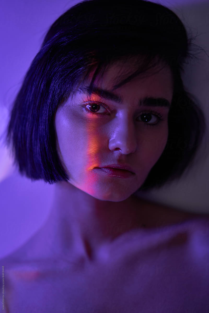 short-haired model with a beam of light on her face
