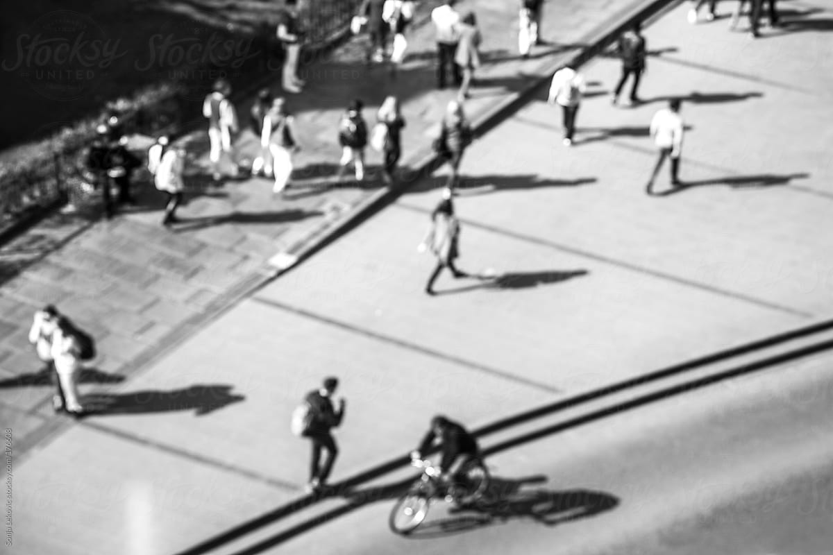 defocused people in the street from above in black and white