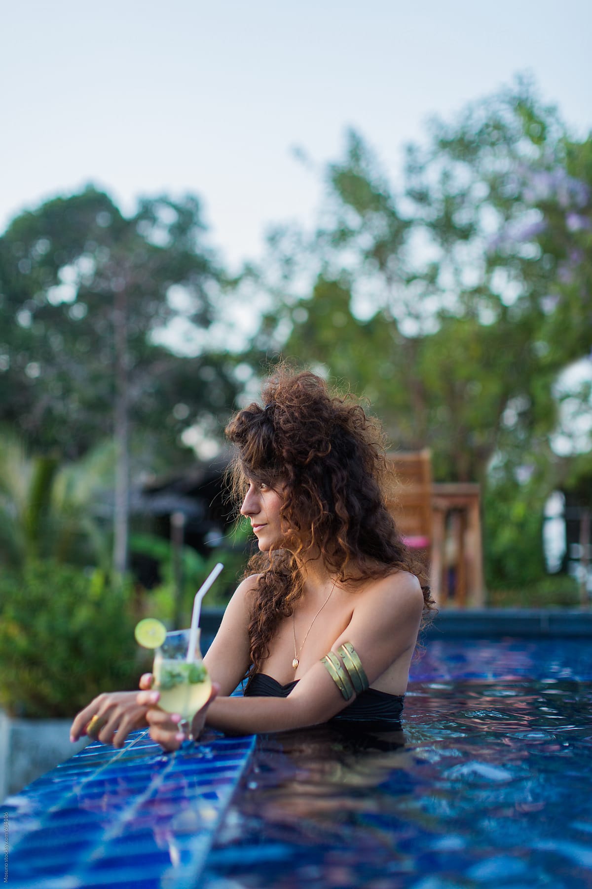 Woman Drinking Cocktail in the Pool