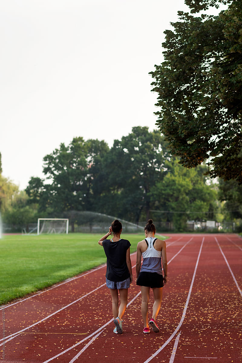 Female training partners early in the morning at the running track