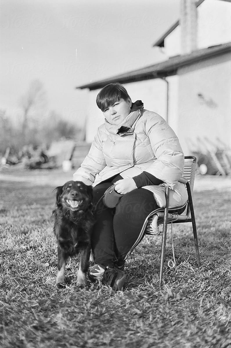 A portrait of woman with a dog in winter