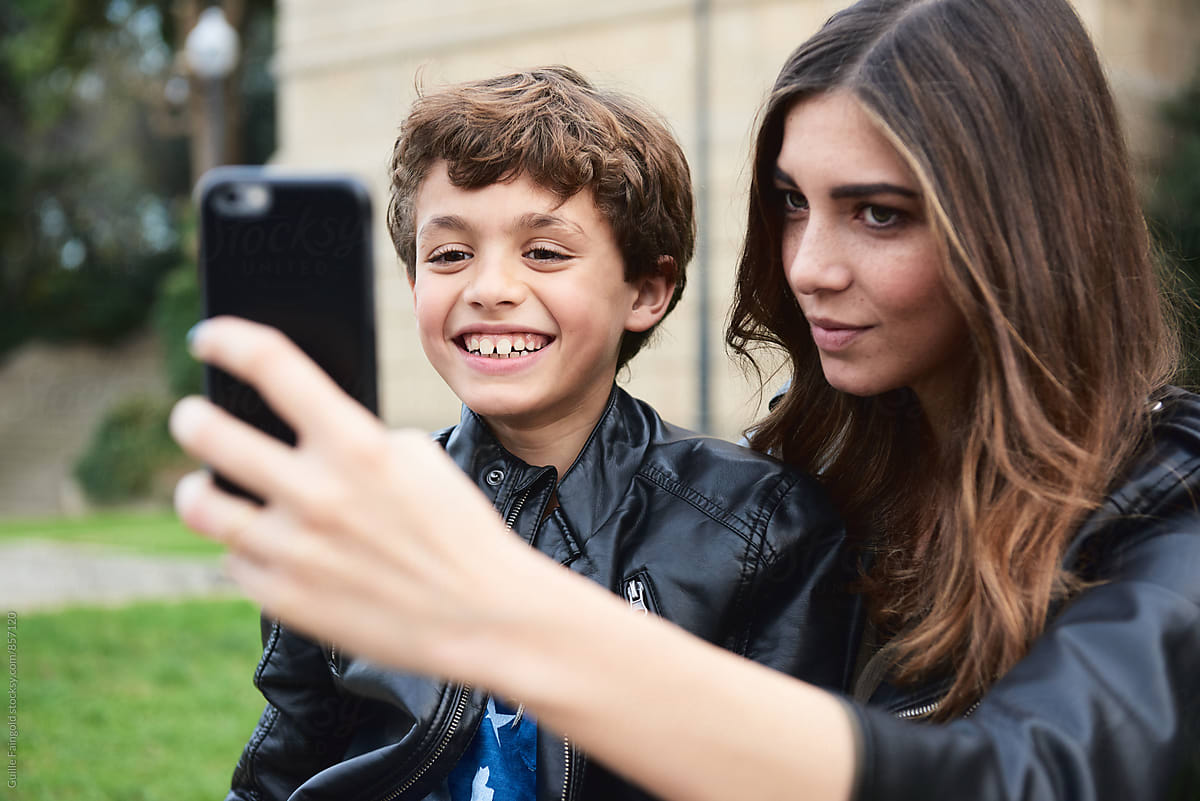 Young woman taking selfie with brother