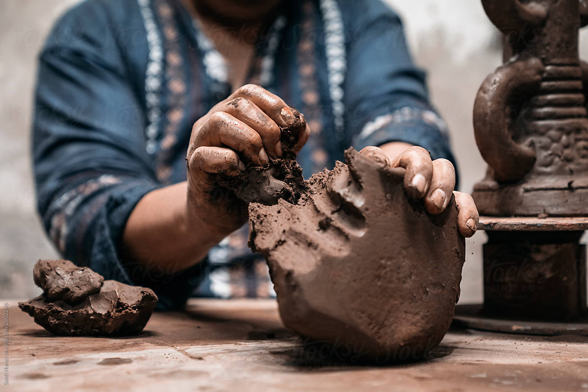 Mexican artisan sculpting with mud