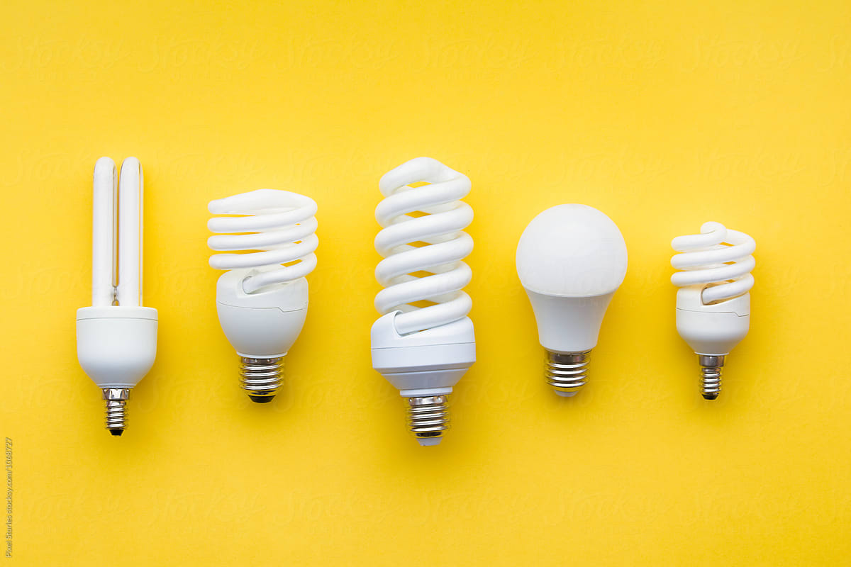 Energy-saving light bulbs on yellow background