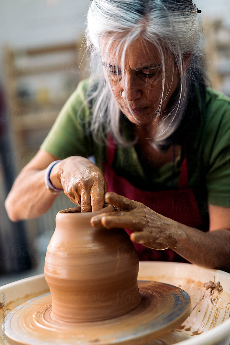 Woman Making Pottery On Spinning Wheel