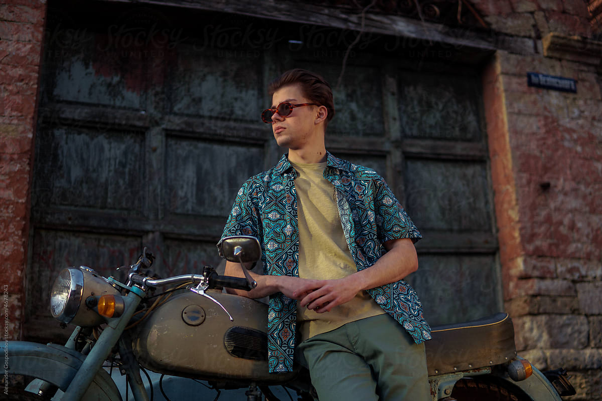 A stylish man and vintage motorcycle