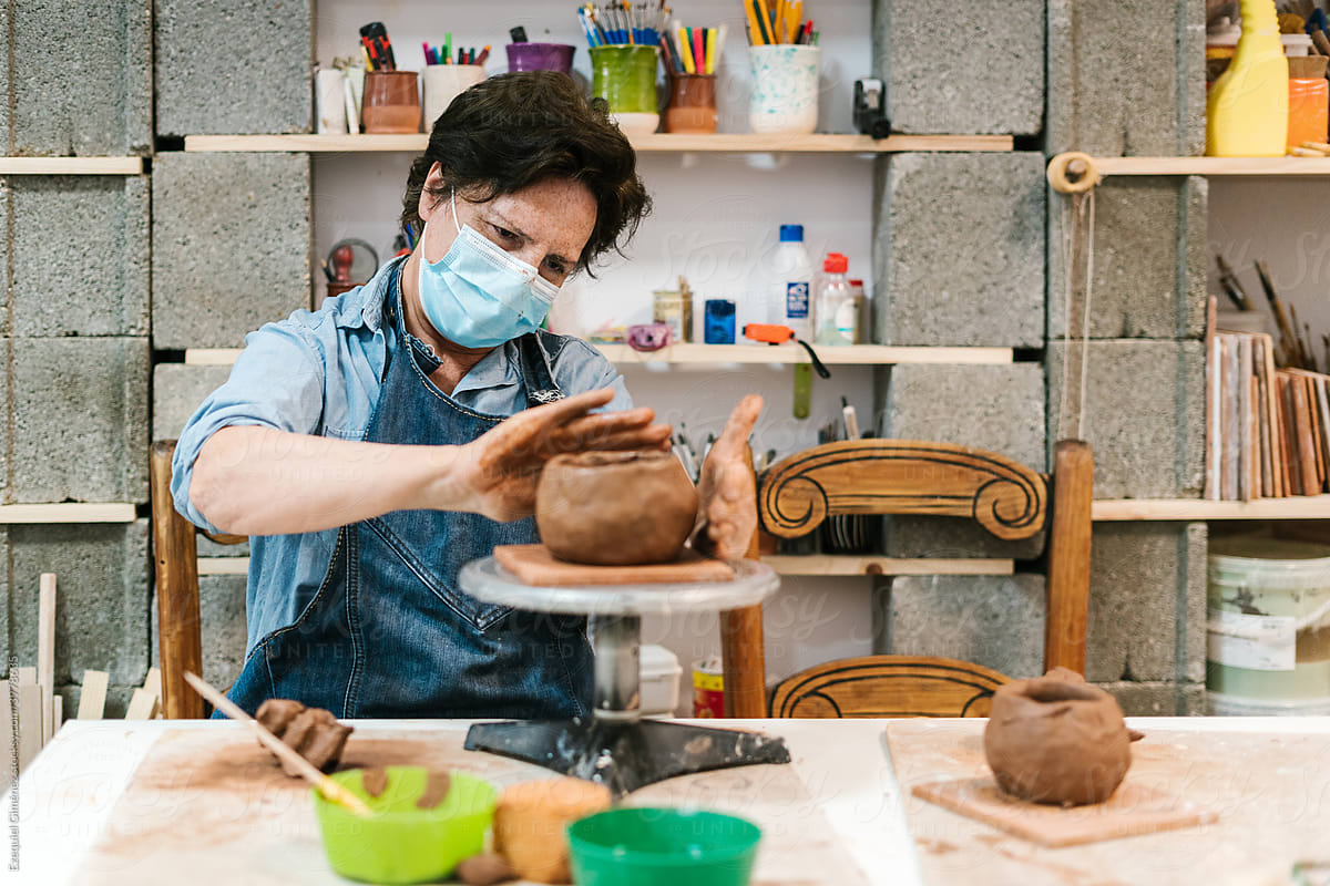 Senior potter creating a clay vessel