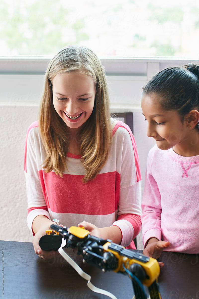 Two young girls experimenting with robotics
