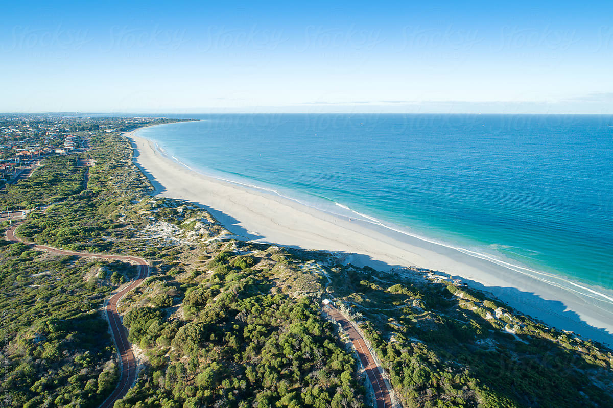 Aerial views over sandy white beaches with blue skies in summer