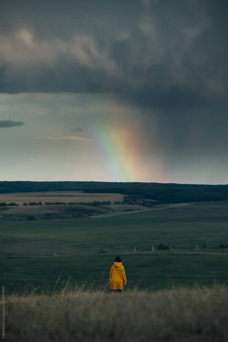 Unidentified woman watching rainbow rays in the sky