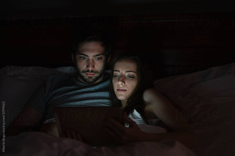 Young couple watching movie on tablet