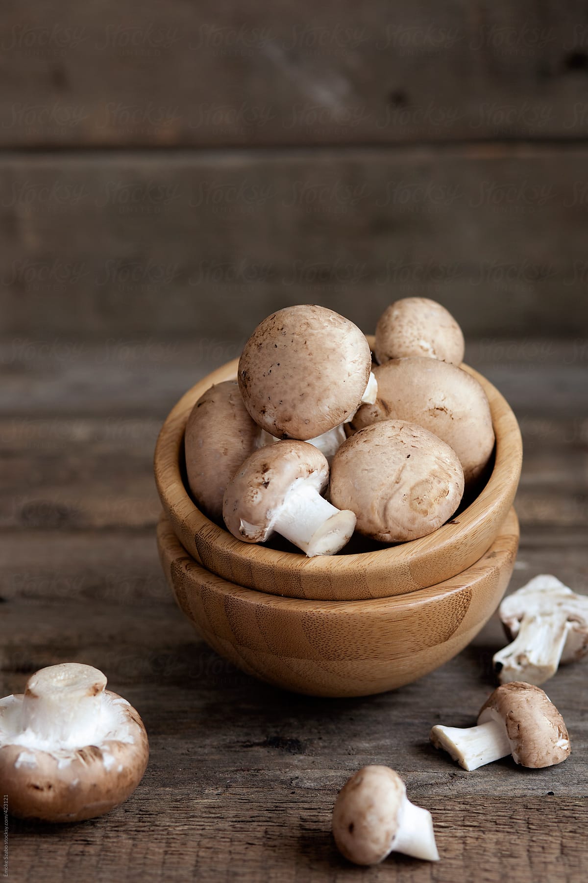 Fresh mushroom in a wooden bowl
