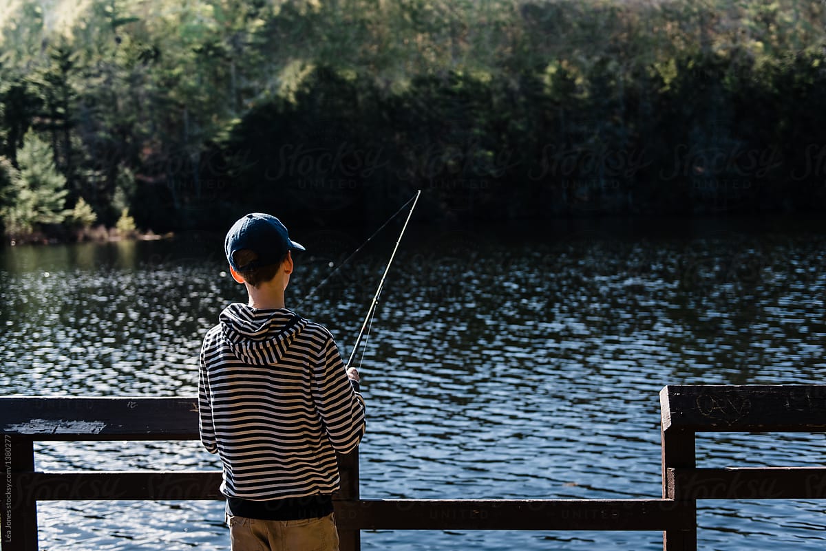 Teen Boy Fishing On Lake by Stocksy Contributor Lea Jones - Stocksy