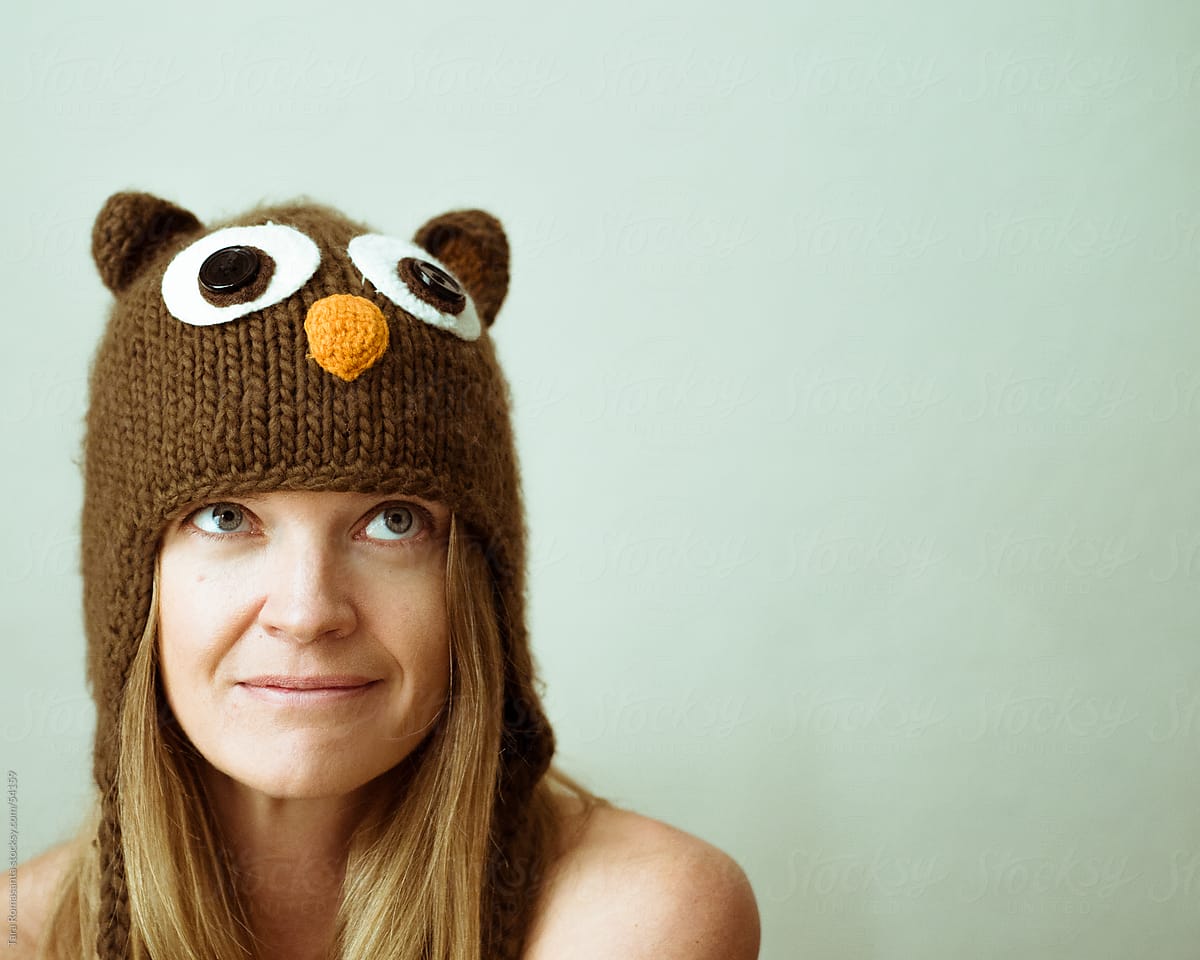 woman wearing an owl winter hat