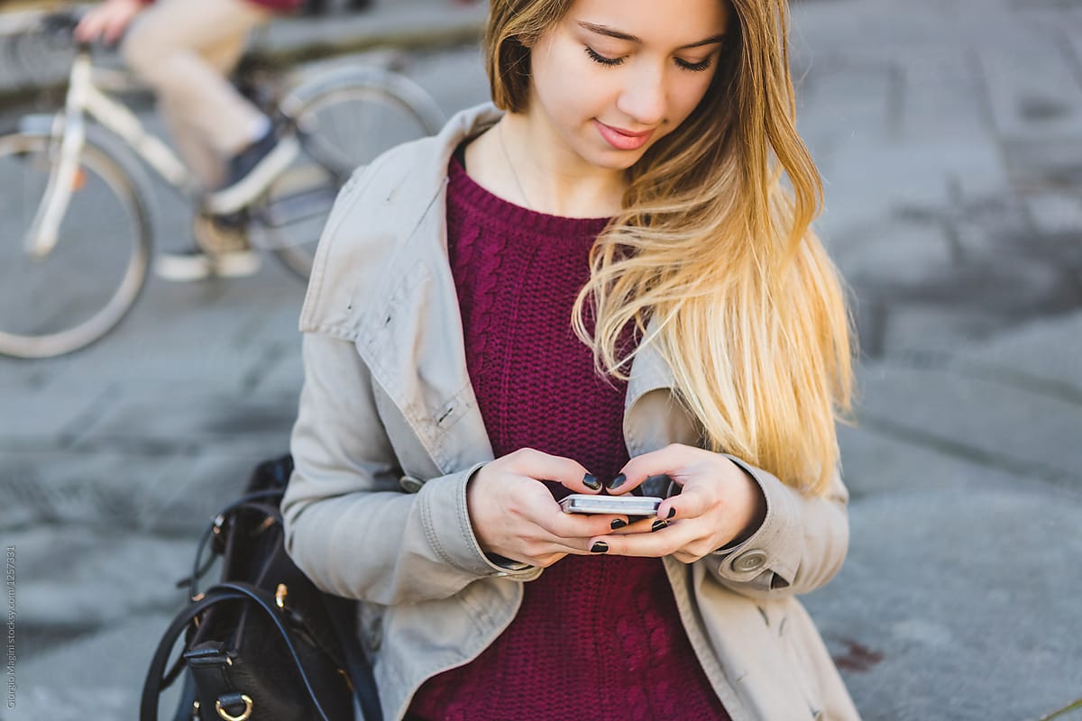 Teenage Girl in Urban Area Texting on a Mobile Phone
