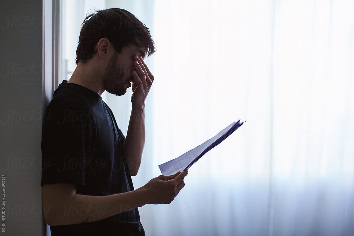 Young man reading script at home.