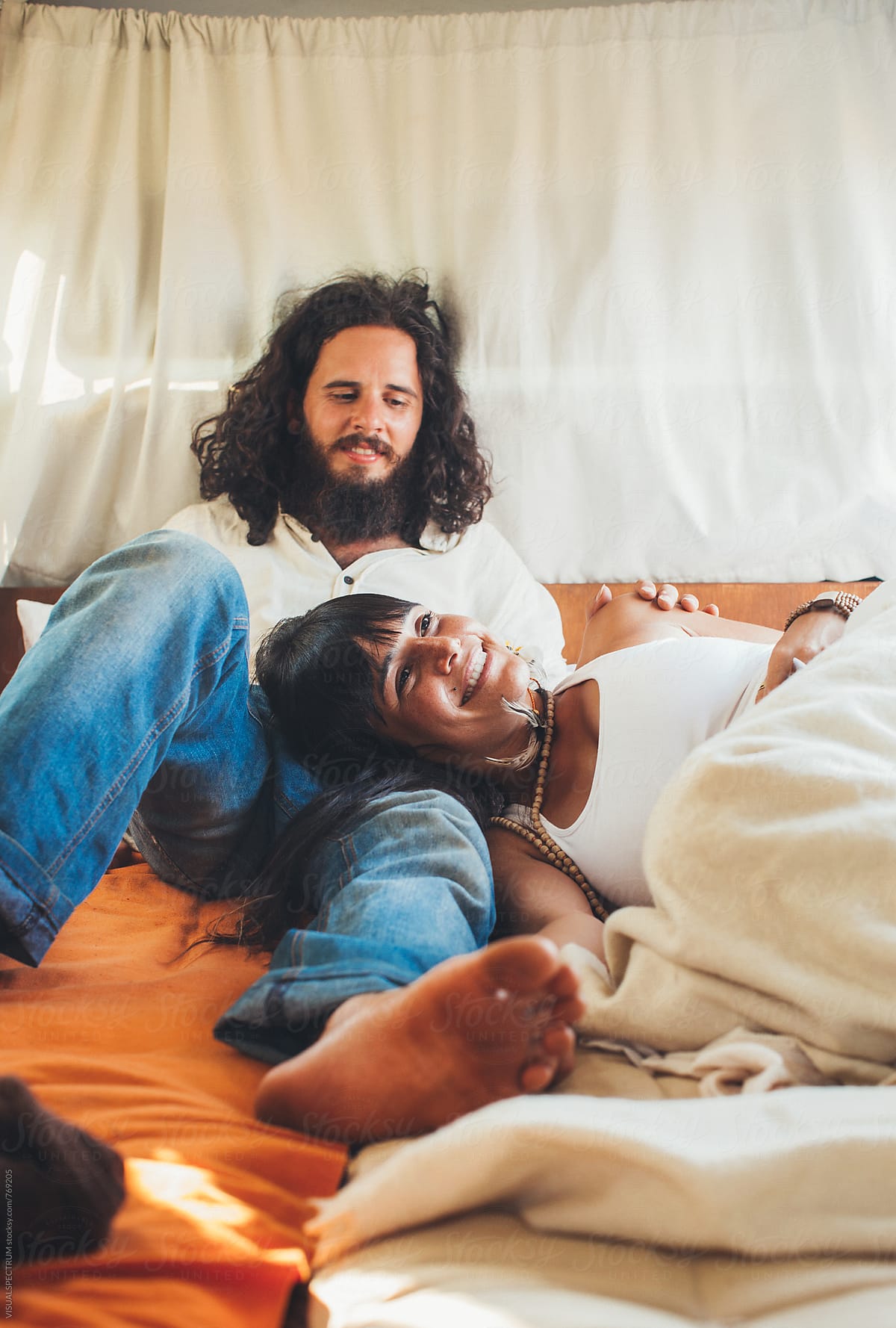 On The Road Heterosexual Hippie Couple Lying And Smiling In Camper Van By Stocksy 