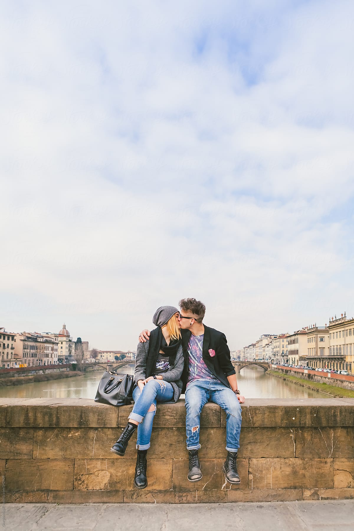 Teenage Couple Kissing by the River in the Old City