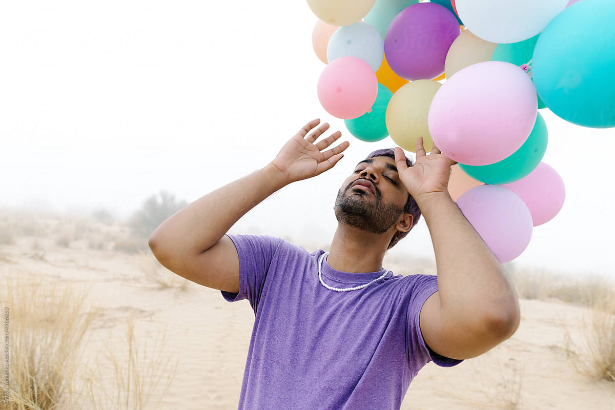A man with balloons outdoors