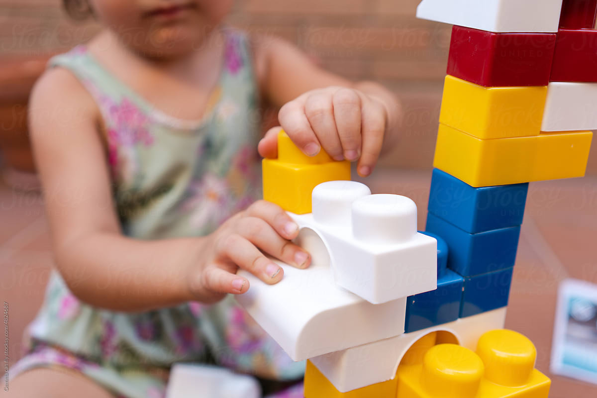 Little girl playing building block