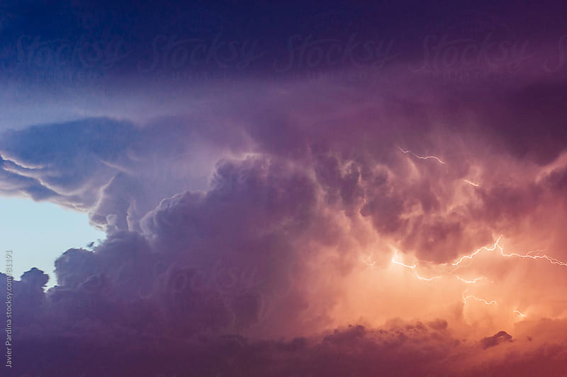 Lightning at sunset with a cloudy sky