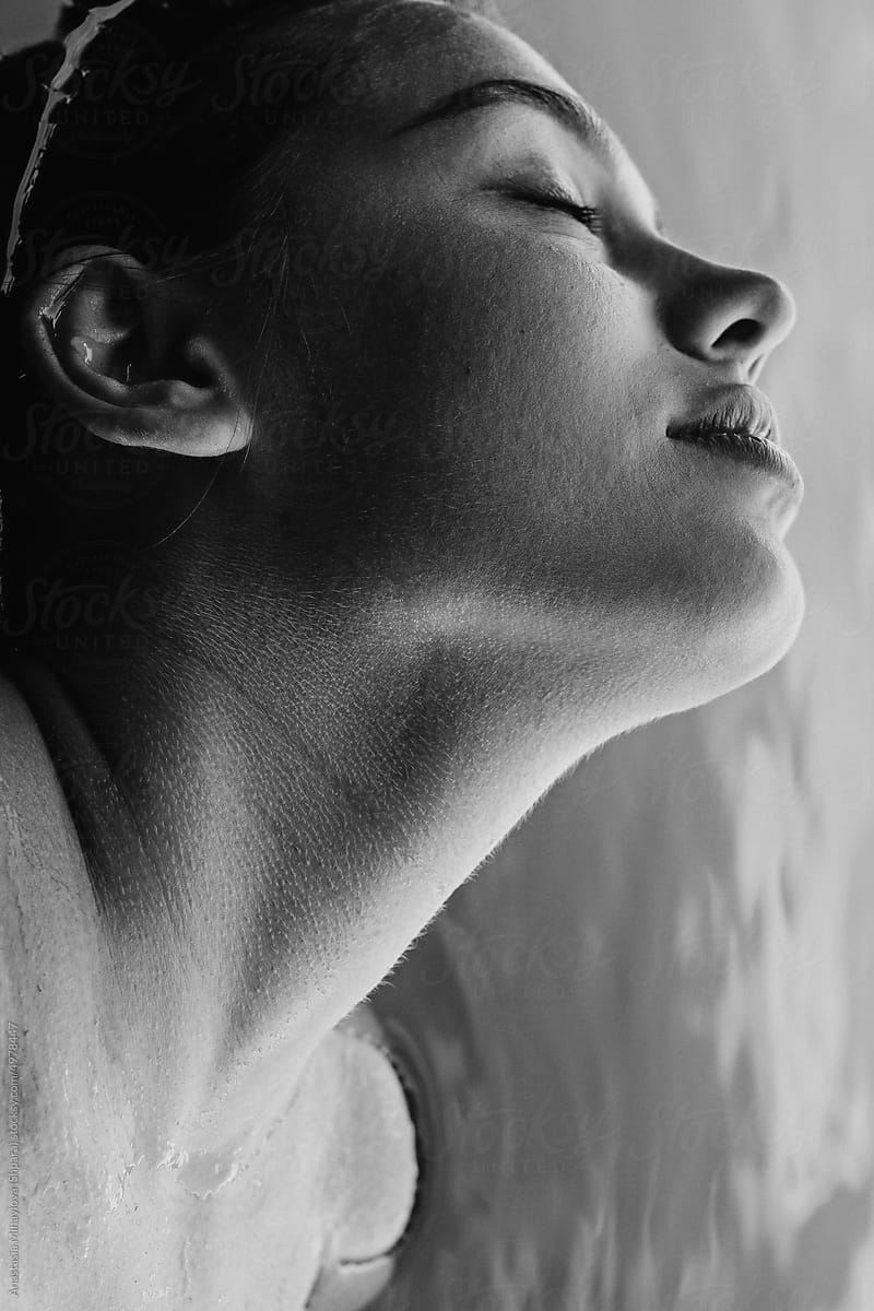 Half-face profile bw portrait female with closed eyes in water