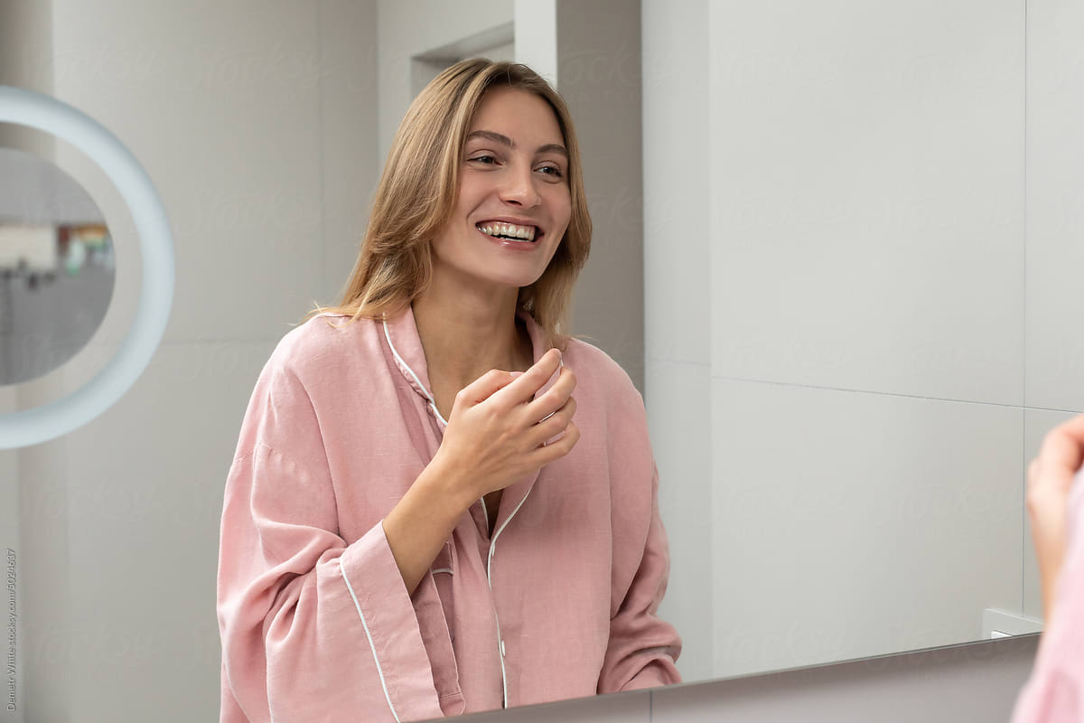 Happy woman in front of mirror