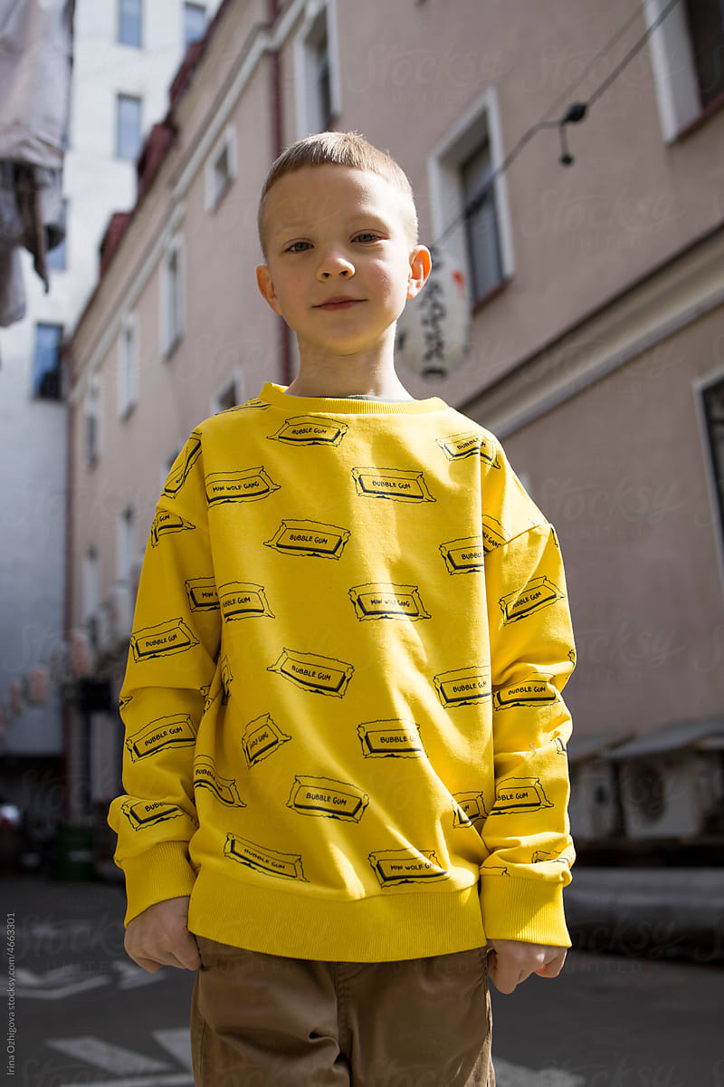 Boy in a yellow sweatshirt outdoor