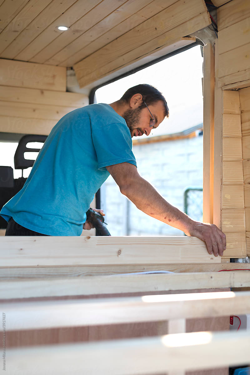 Man building bed in Camper Van