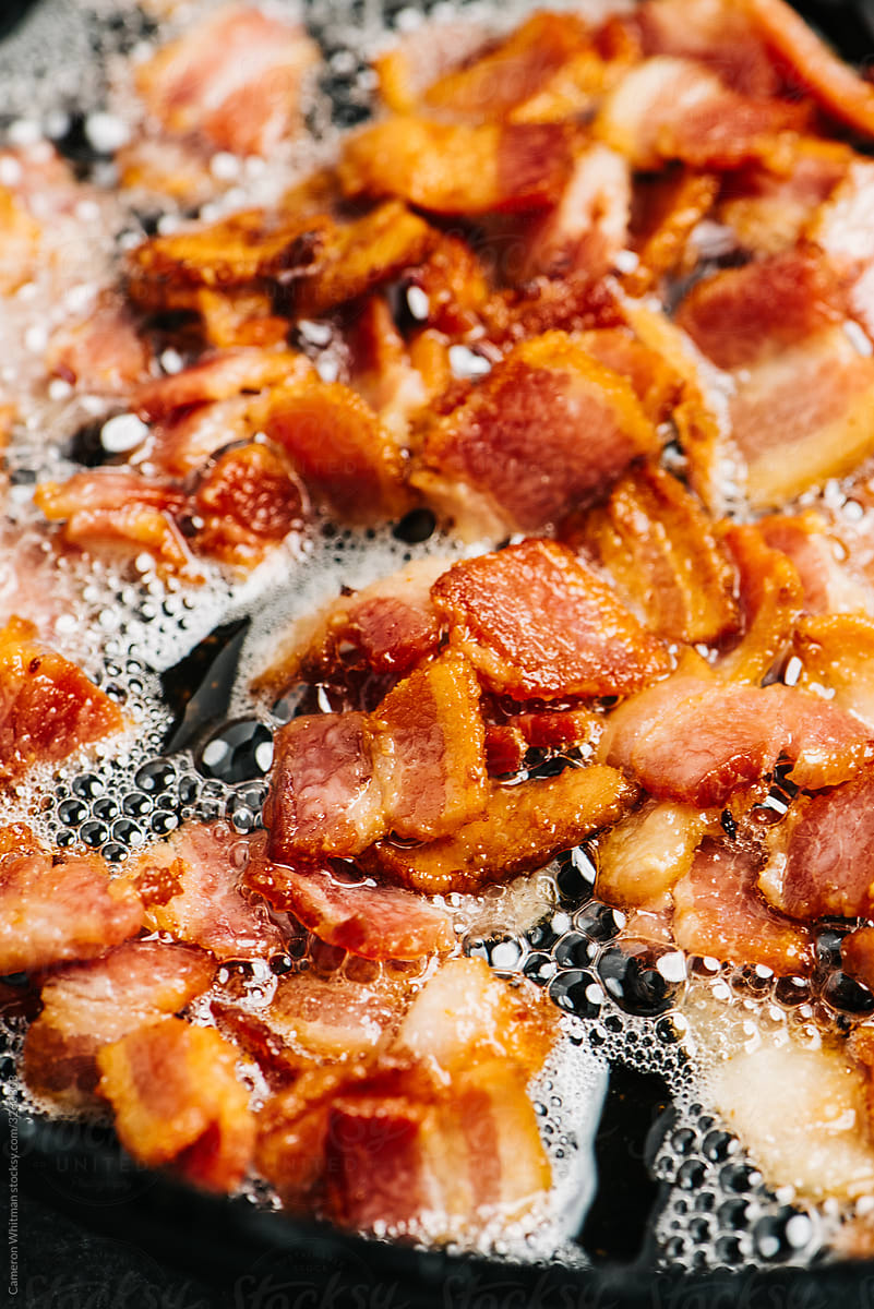Sizzling bacon in an iron skillet