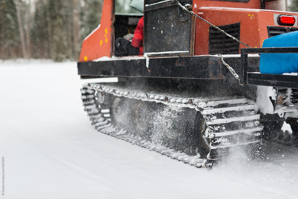 Caterpillar tracks of vintage snow grooming machine get good traction in snow