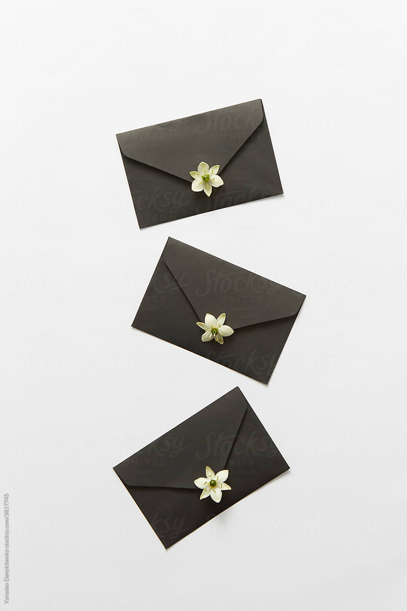 Black envelopes with blooming white flowers