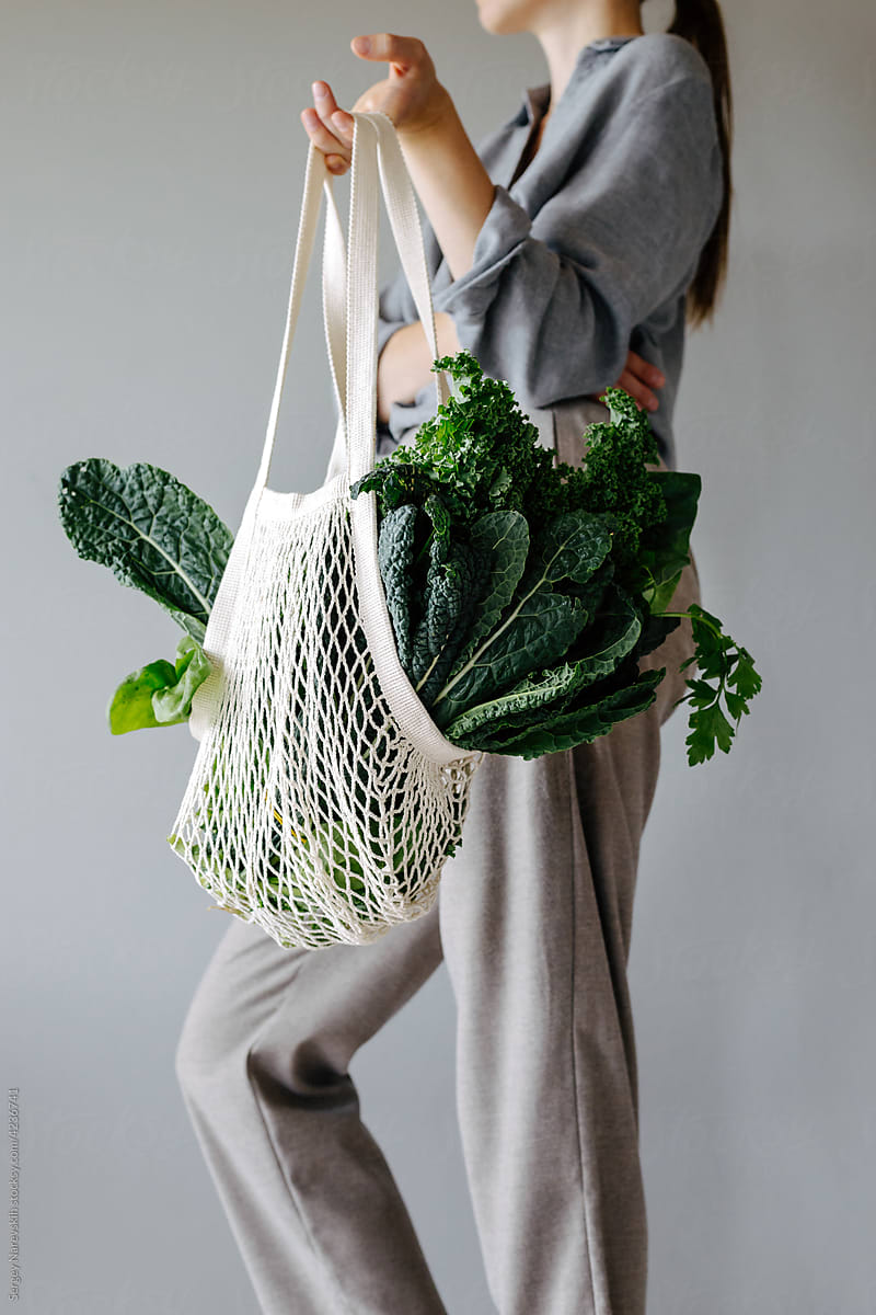 Woman with groceries in mesh bag