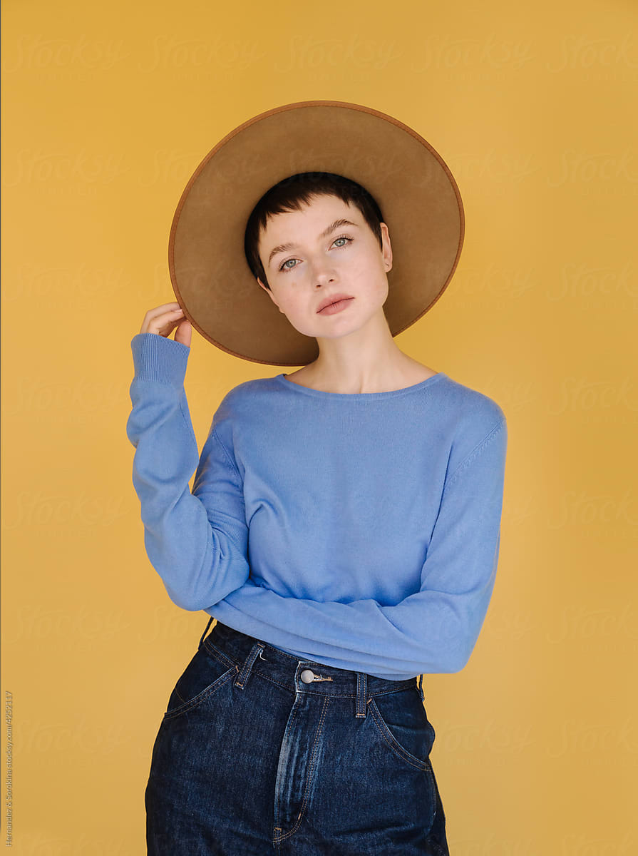 Woman With Hat Posing At Yellow Background