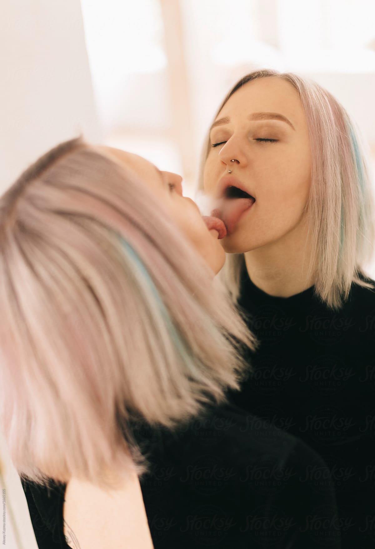 young woman kissing  and licking her reflection in the mirror