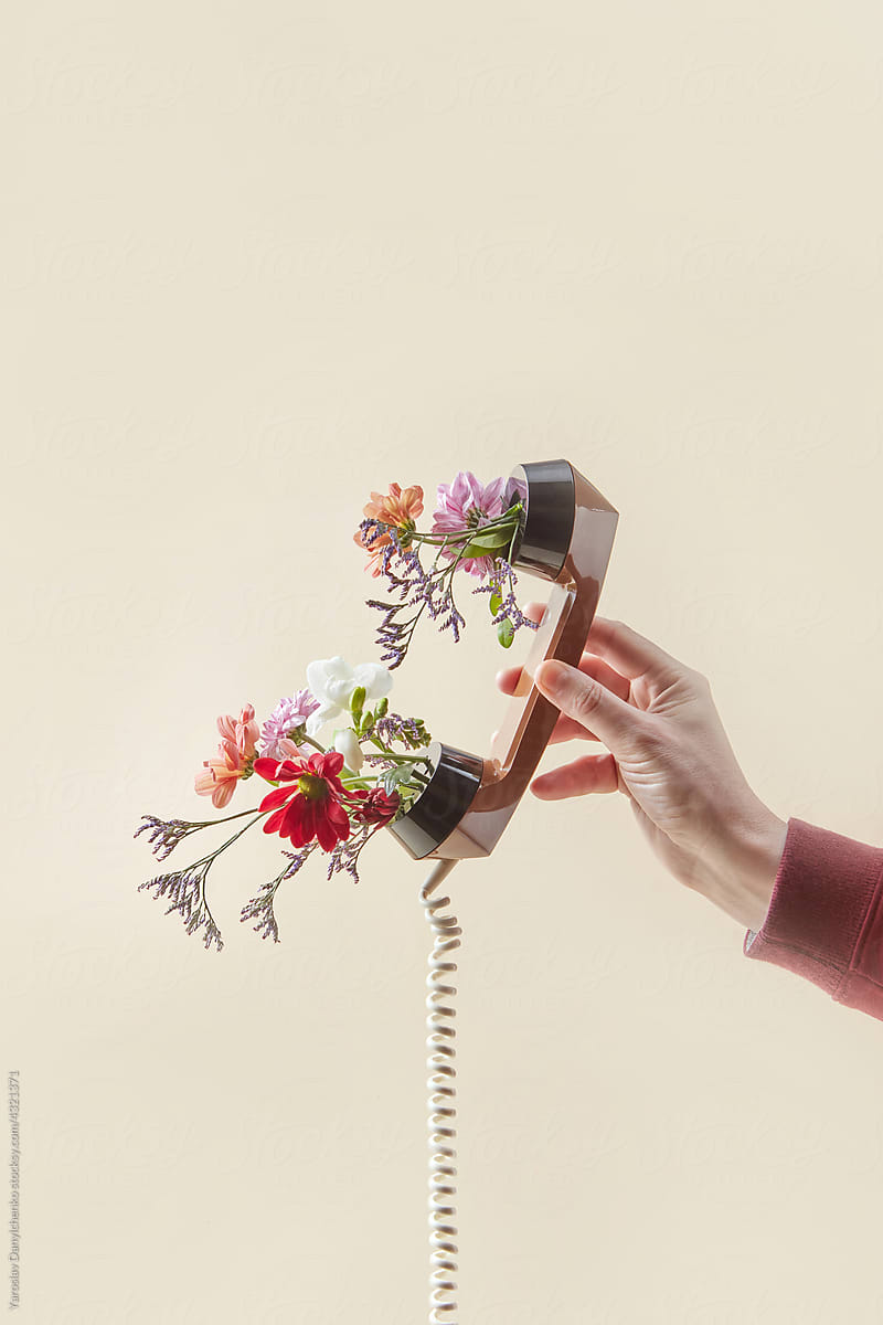 Man holding phone handset with spring flowers