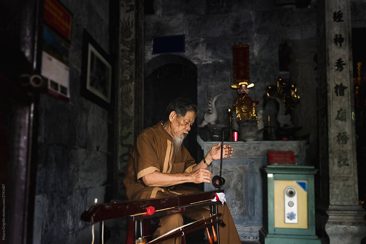 Man playing an instrument in a temple