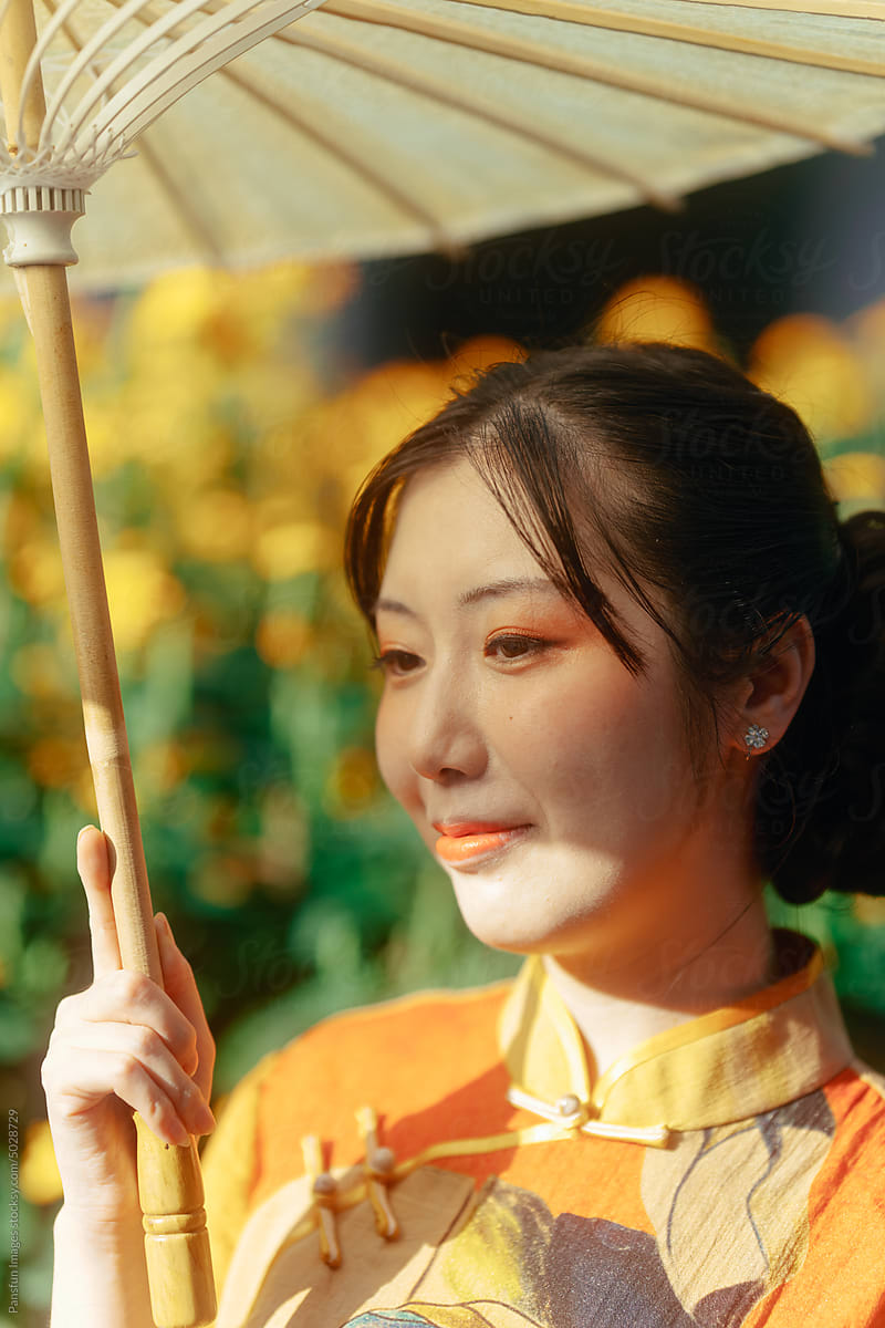 Elegant Asian woman with umbrella on hand