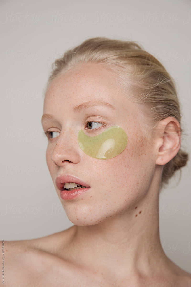 Young freckled model with green under eyepatches
