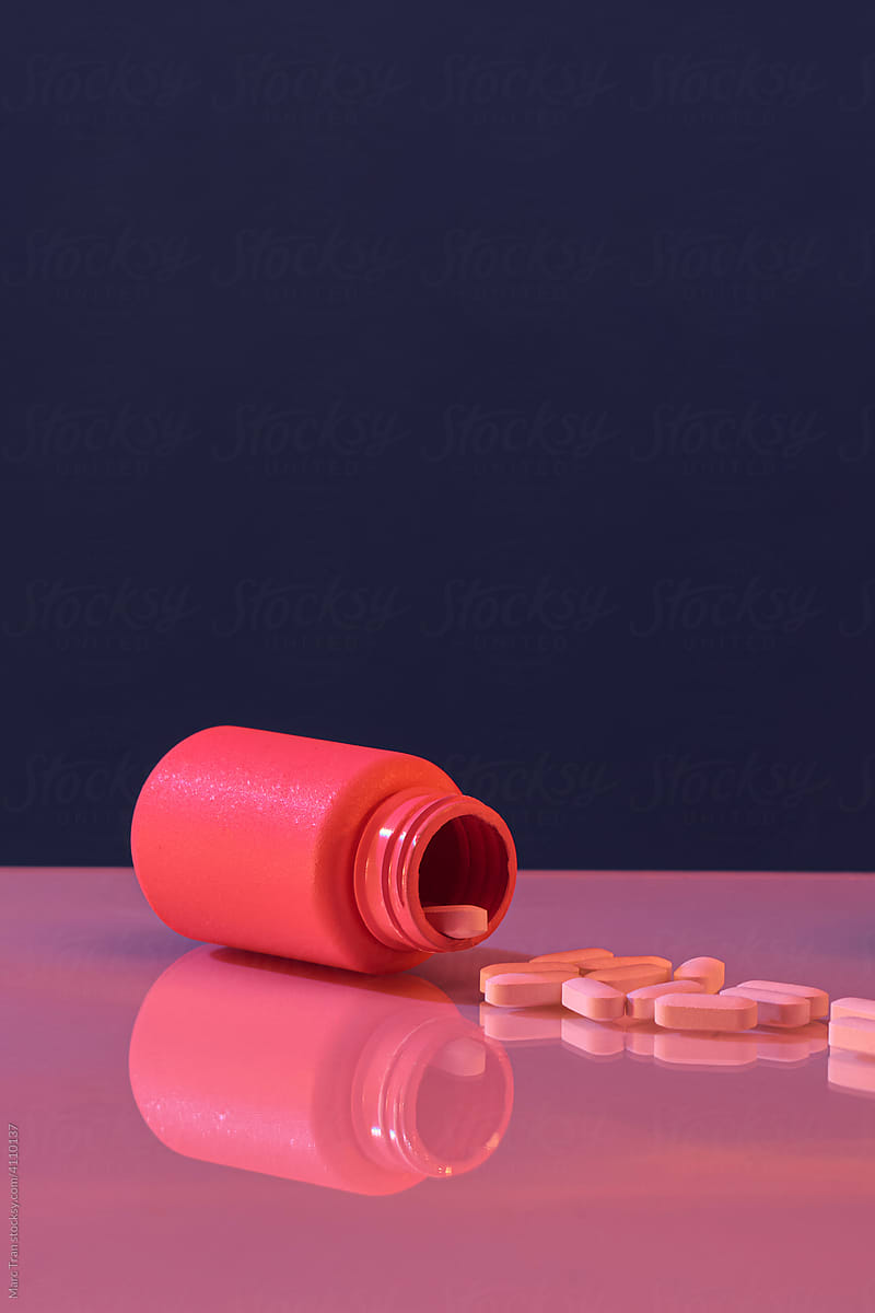 Pills spilling out of the bottle