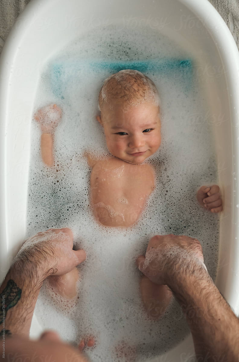 Baby Relaxing In The Bathub During Bath Time