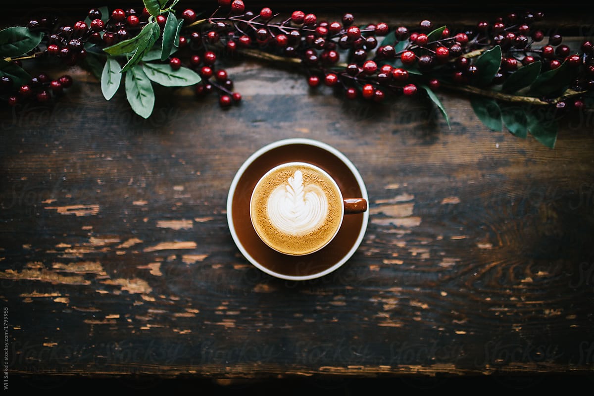Christmas coffee on rustic wooden bench.