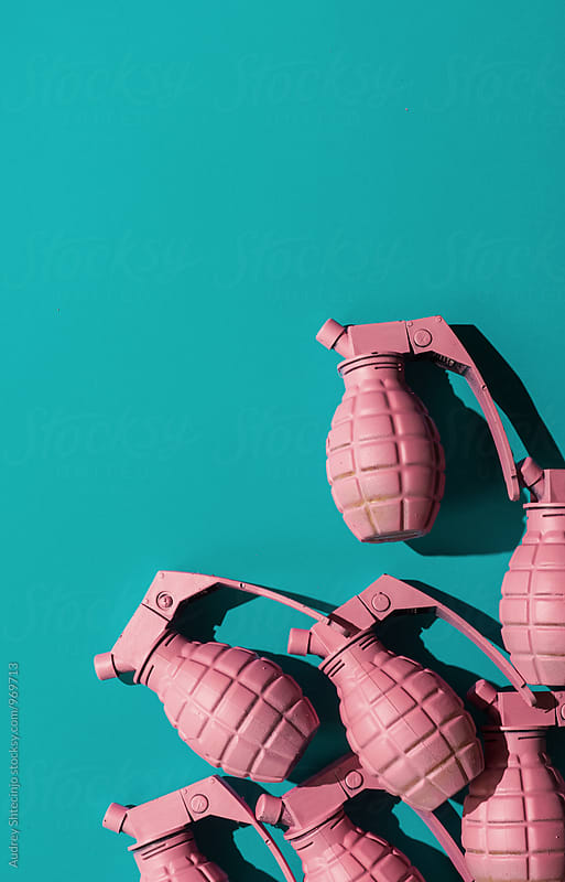 Pink hand grenades on blue background.