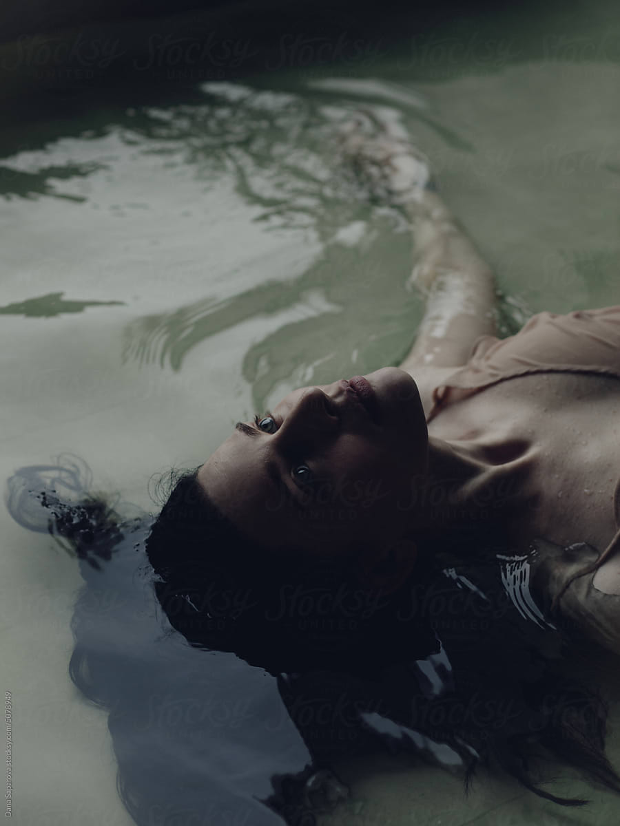 Beautiful woman floating in a pool of water
