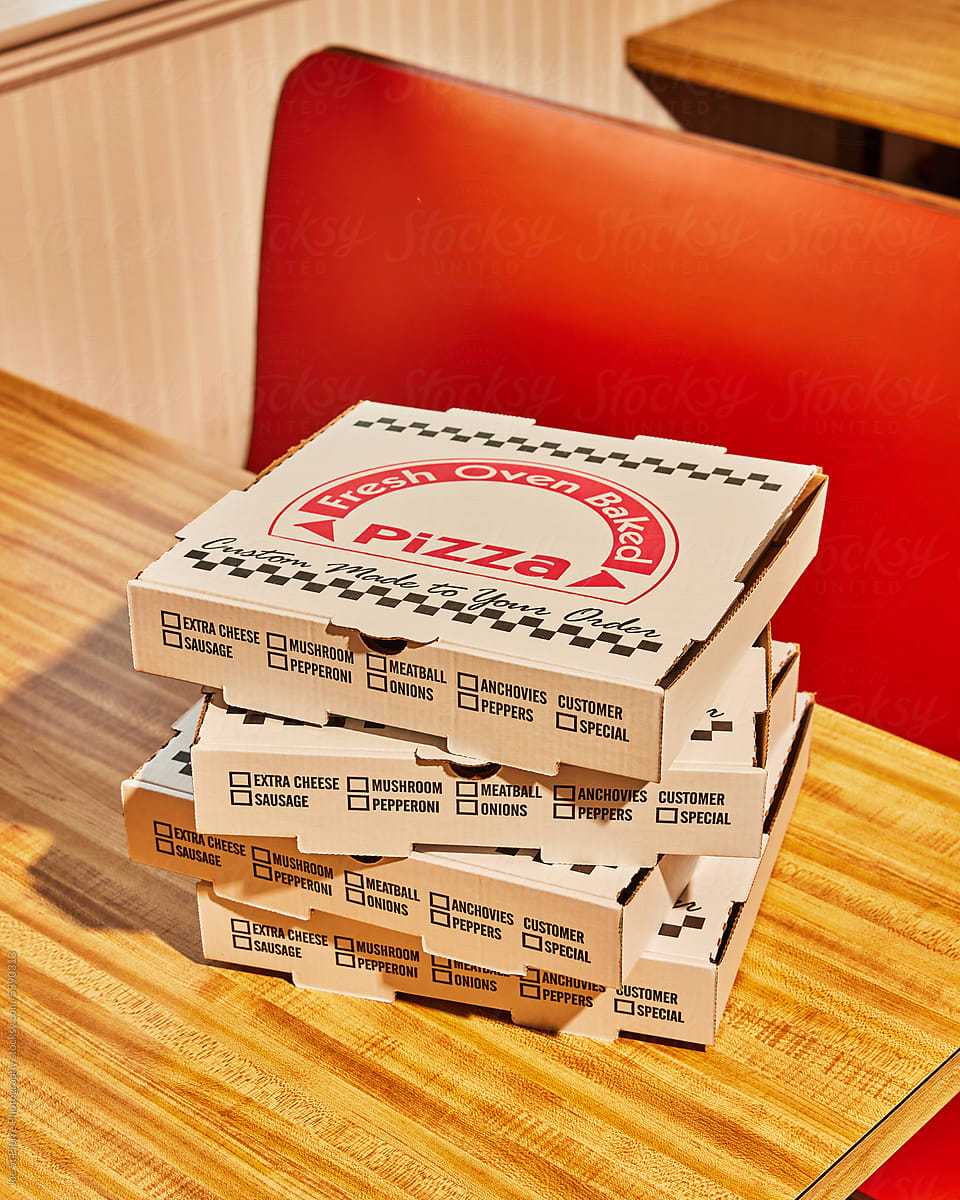 A Tower Of Four Pizza Boxes