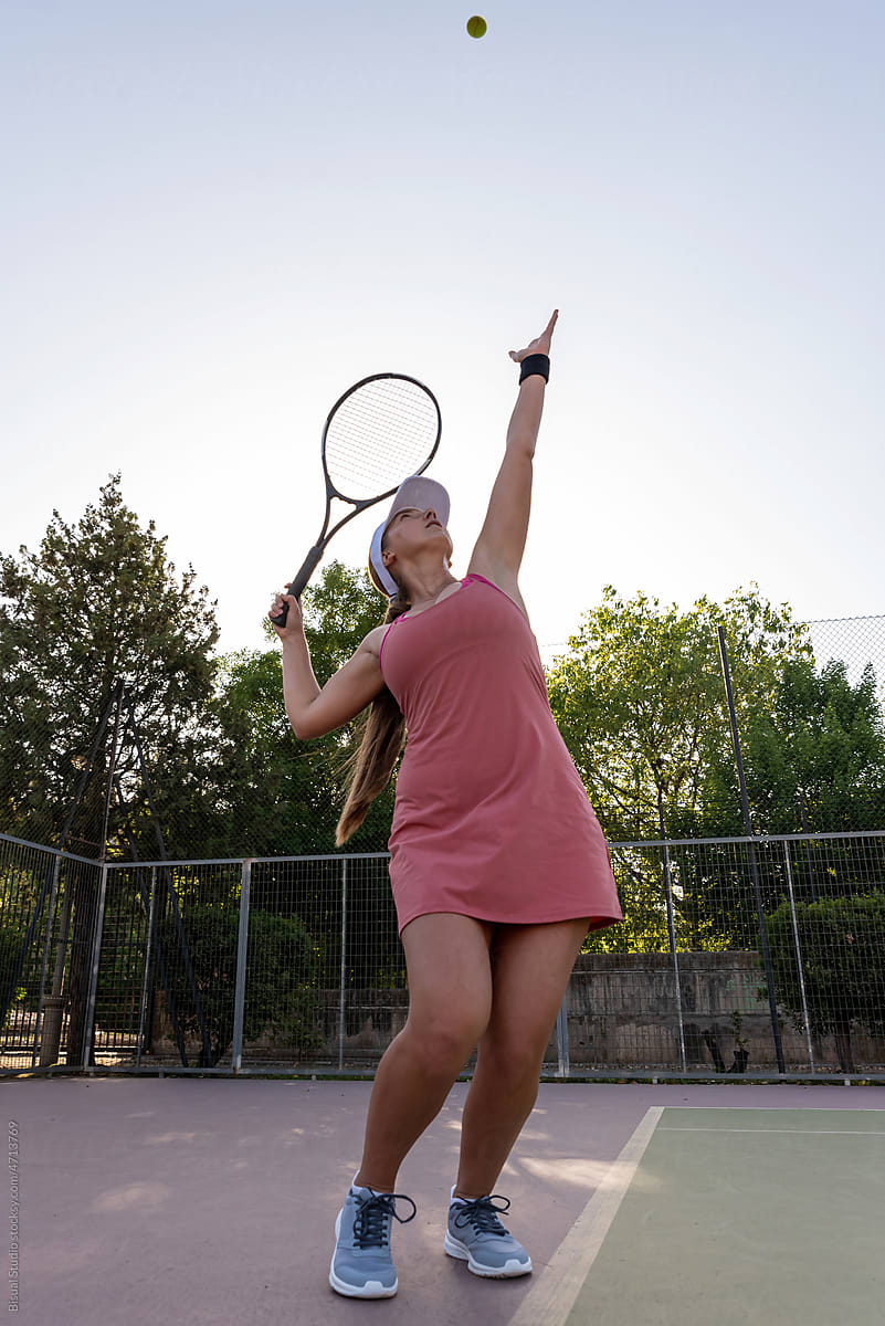 Tennis player serving ball during match