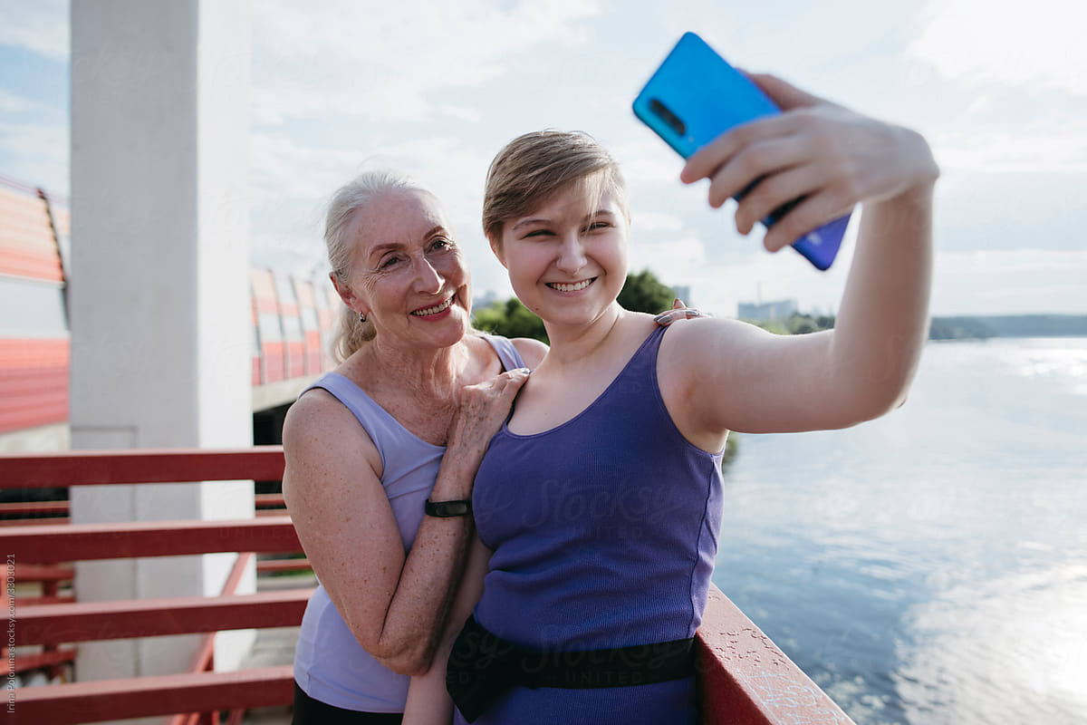 Grandma and granddaughter take selfies.