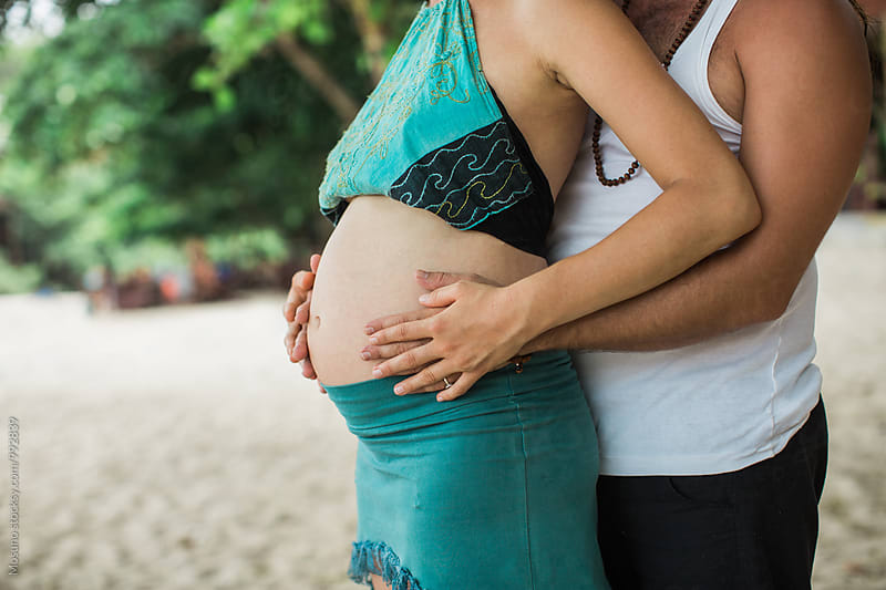 Man Holding Woman\'s Pregnant Belly