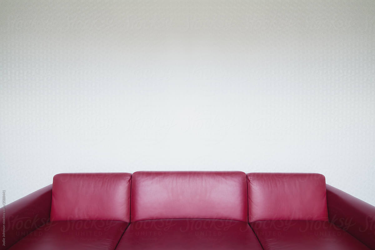 Red leather sofa with geometrical wallpaper